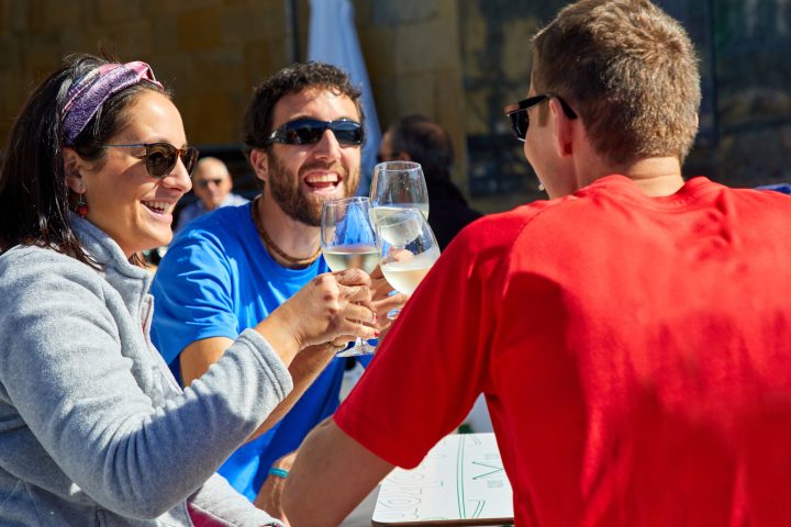 a group of people holding wine glasses