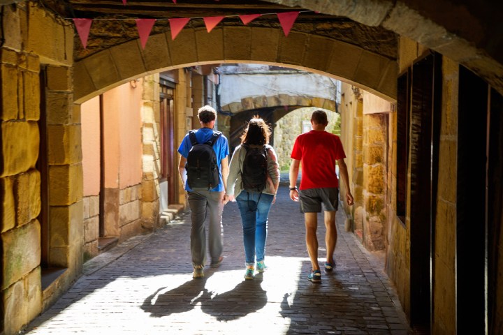 a group of people walking on a sidewalk