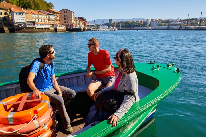 a group of people in a boat on a body of water