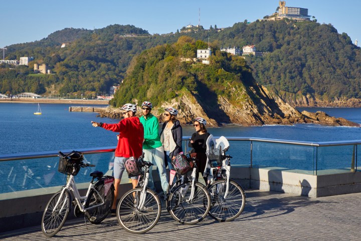 a group of people riding on the back of a bicycle
