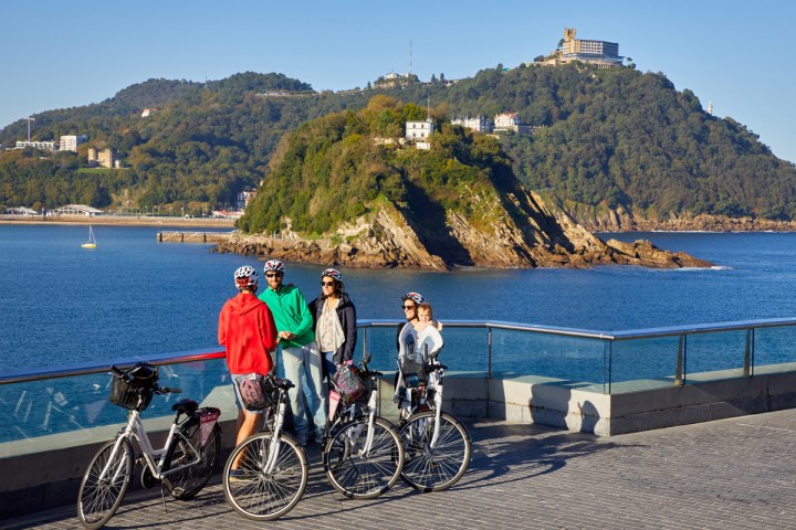 a group of people standing in front of a body of water