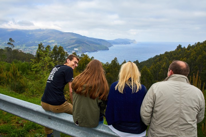 a group of people standing on top of a mountain