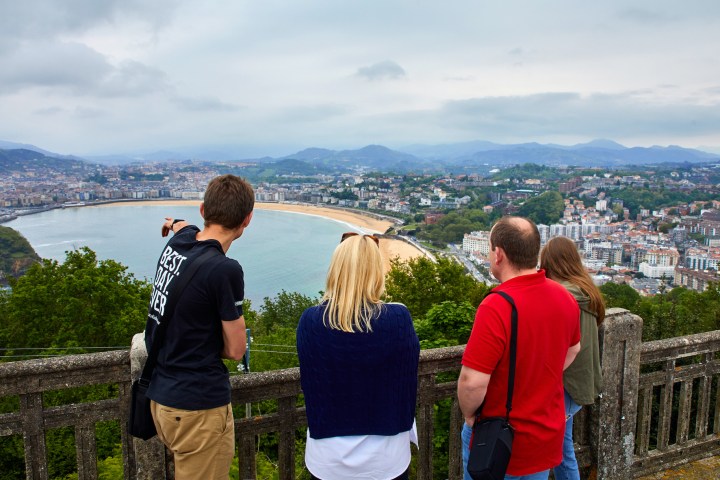 a man and a woman standing in front of a mountain