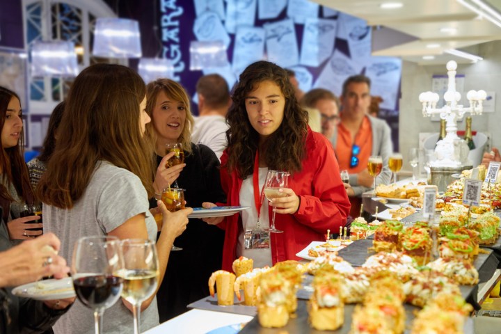 a group of people sitting at a table with food
