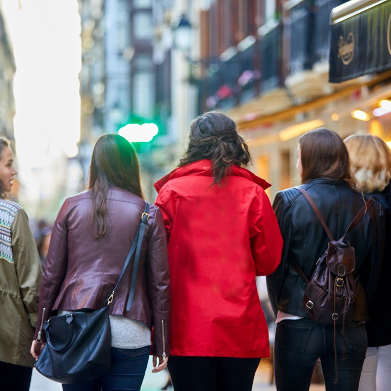 a group of people walking on a city street
