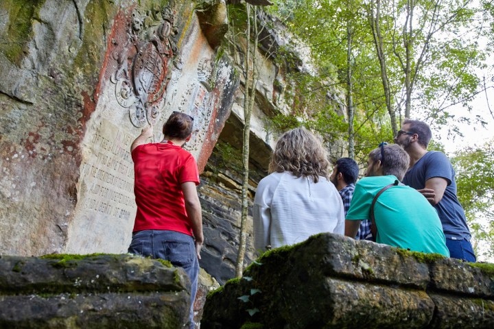 a group of people sitting on a rock