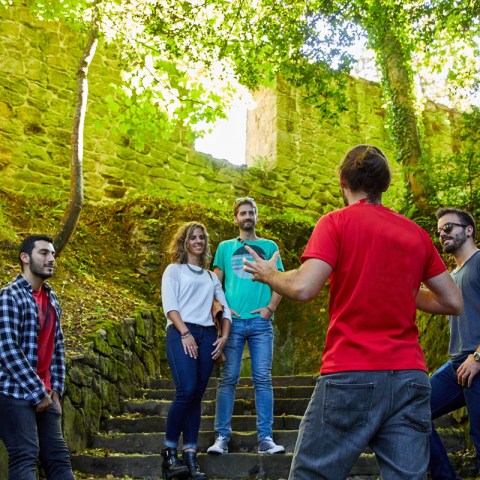 a group of people standing next to a tree